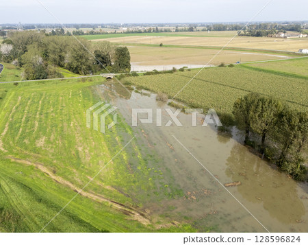 Flooded farmlands by the river swollen bursting it banks creating disasters for farmers, Italy Flooded farmlands by the river swollen bursting it banks creating disasters for farmers, Italy 128596824