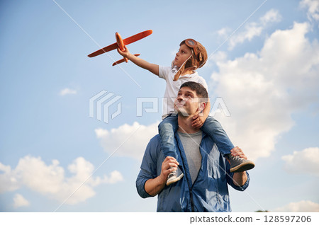 With aviator glasses, playing with toy plane. Father and little son are having fun outdoors 128597206