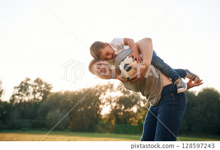 Soccer ball in hands. Father and little son are playing and having fun outdoors 128597243