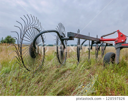Agricultural machinery, wheel-finger rake. close-up. tractor-mounted rakes. 128597826