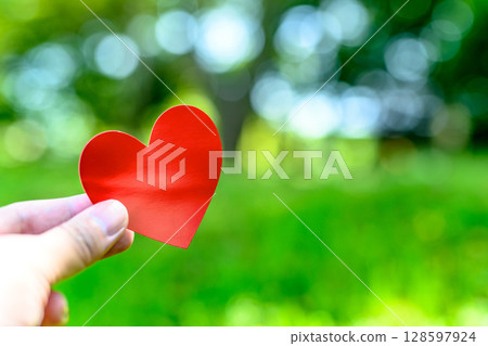 Hands holding a heart in outdoor nature Love Encounter Background material Background Daytime color soft Hands holding a heart in outdoor nature Love Encounter Background material Background Daytime color soft 128597924