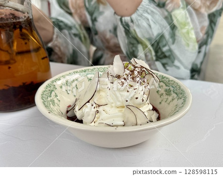 Delicious dessert of cherries, coconut cream and grated chocolate. High quality photo 128598115