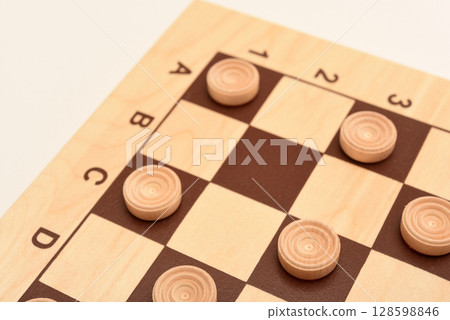 Wooden checkers on the board. The board game checkers. 128598846