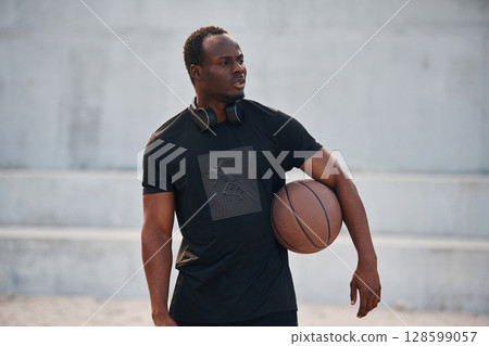 Holding ball in hands. Young black man Holding ball in hands. Young black man 128599057