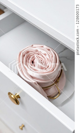 Pink Satin Ribbon Rolled in White Drawer 128600173