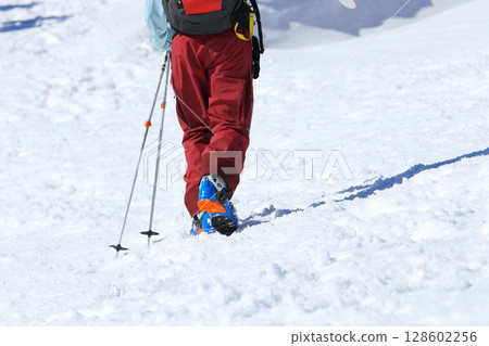 Backcountry skiers climbing snowy mountain in Hakuba Happo-one, Northern Alps, Japan Backcountry skiers climbing snowy mountain in Hakuba Happo-one, Northern Alps, Japan 128602256