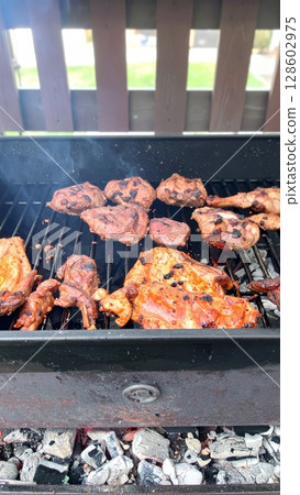 Juicy barbecue meat on the grill, close view, summer barbecue bliss background 128602975