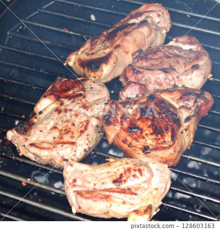 Juicy barbecue meat on the grill, close view, summer barbecue bliss background 128603163