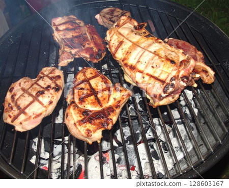 Juicy barbecue meat on the grill, close view, summer barbecue bliss background 128603167