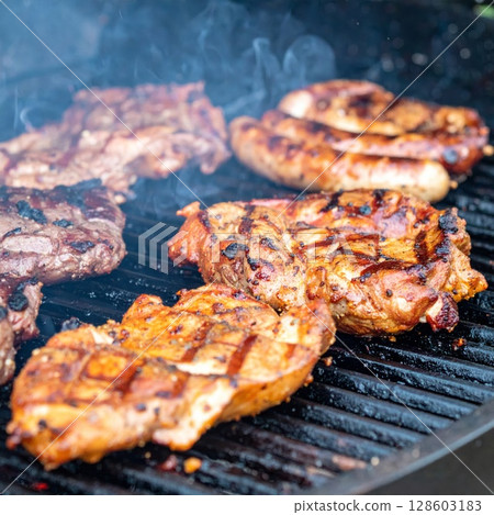 Juicy barbecue meat on the grill, close view, summer barbecue bliss background 128603183
