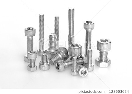 Bolts and nuts (machine parts image) 128603624