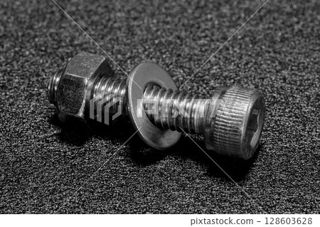 Bolts and nuts (machine parts image) 128603628