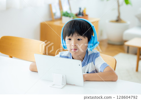 Boy taking online classes 128604792