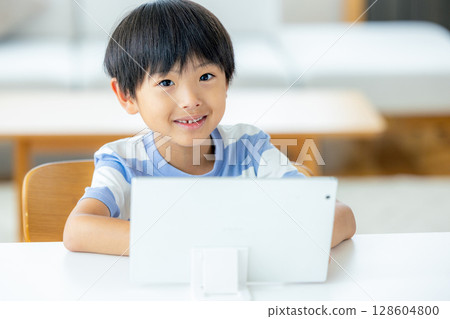 A boy using a tablet A boy using a tablet 128604800