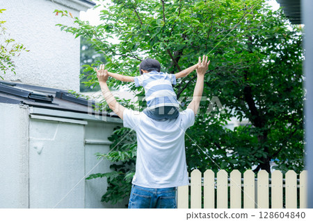 Dad carrying a child on his shoulders Dad carrying a child on his shoulders 128604840