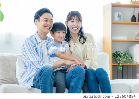 A young family relaxing in the living room A young family relaxing in the living room 128604854