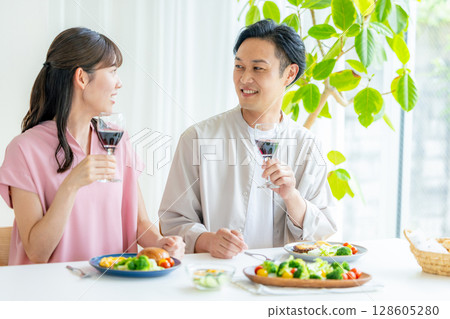 Young men and women toasting with red wine Young men and women toasting with red wine 128605280