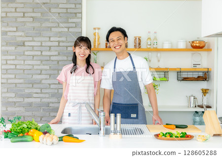 Young couple, kitchen, vegetables Young couple, kitchen, vegetables 128605288