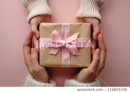 Female and daughters hands holding gift pink box, mother day , new year, birthday concept, generative ai Female and daughters hands holding gift pink box, mother day , new year, birthday concept, generative ai 128605299