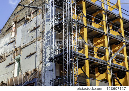 a partially demolished old building exhibiting significant disrepair. 128607117