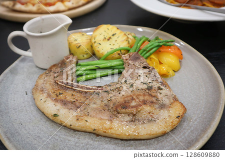 pork steak or grilled pork and salad or pork chop pork steak or grilled pork and salad or pork chop 128609880