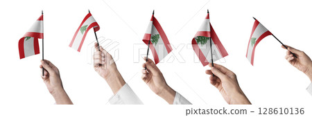 The Lebanon flag in hand in different angles on a white background 128610136