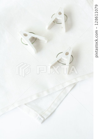 White clothespins and cross 128611079