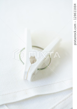White clothespins and cross 128611084