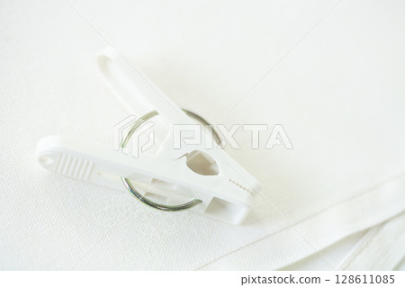 White clothespins and cross 128611085