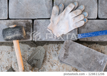 Laying paving stones on cement mortar. Laying a garden path made of tiles. Self-laying of concrete paving slabs in the courtyard of the house. do it yourself. DIY Laying paving stones on cement mortar. Laying a garden path made of tiles. Self-laying of concrete paving slabs in the courtyard of the house. do it yourself. DIY 128611206