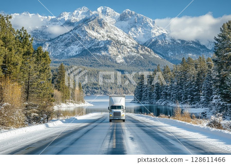 White Semi Truck Driving Through Snowy Mountain Road 128611466