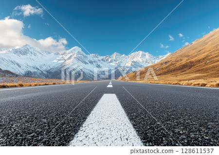 Ground Level Road View with Mountains in Background Ground Level Road View with Mountains in Background 128611537