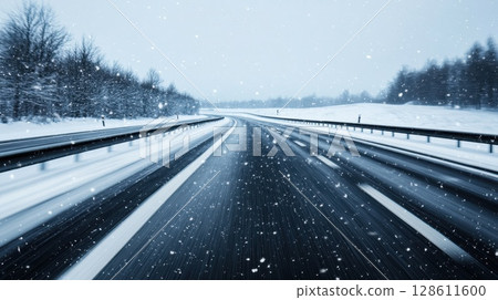 Snowy Highway Winding Through a Serene Landscape Snowy Highway Winding Through a Serene Landscape 128611600