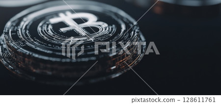 A close up of a black coin with the letter B on it A close up of a black coin with the letter B on it 128611761