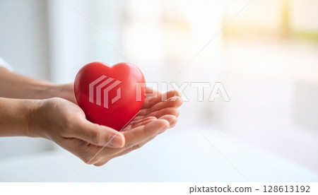 Hearts held up in the palms of both hands Hearts held up in the palms of both hands 128613192