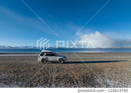 Offroad car at the side of beautiful lake in tibet,China 128613740