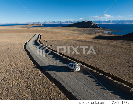 Aerial view of offroad car running on corrugated road in the remote part of Tibet, China Aerial view of offroad car running on corrugated road in the remote part of Tibet, China 128613772