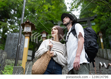 Inbound tourists standing in front of the torii gate Inbound tourists standing in front of the torii gate 128614796