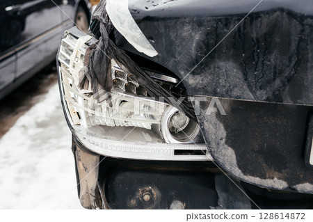 broken rear car headlight, broken headlight close up. Consequences of an accident 128614872