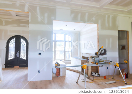 Prepare modern living space during home renovation featuring tools unfinished walls during works day 128615034