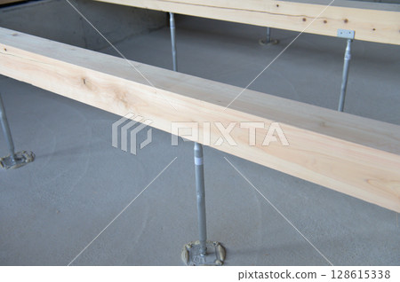 Floor beams and joists of a house under construction 128615338