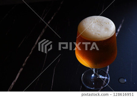 Beer - A glass of chilled beer with fine foam Beer - A glass of chilled beer with fine foam 128616951