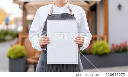 Menu mockup held by person in apron with white shirt standing outdoors with blurred background for restaurant or cafe concept Menu mockup held by person in apron with white shirt standing outdoors with blurred background for restaurant or cafe concept 128617075