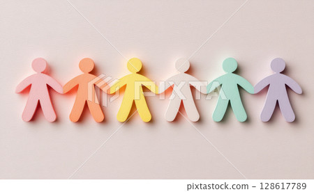 Inclusive workplace culture is represented by colorful paper cutout figures holding hands symbolizing unity and diversity in positive environment Inclusive workplace culture is represented by colorful paper cutout figures holding hands symbolizing unity and diversity in positive environment 128617789