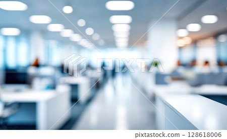 Blurred modern office interior with bright lighting and white desks creating calm and professional atmosphere in spacious workspace environment 128618006