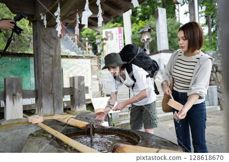 Foreign tourists purifying themselves at the Chozuya (purification fountain) 128618670