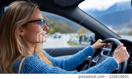 Young caucasian female driving on mountain road with scenic view. 128618691
