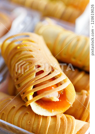 Stack of pancake roll filled with assorted filling. 128619026