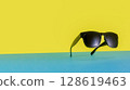 Suspended Sunglasses on Colorful Blue and Yellow Background 128619463