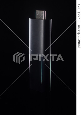 Minimalist Close-Up of USB-C Streaming Stick on Black Background 128619464